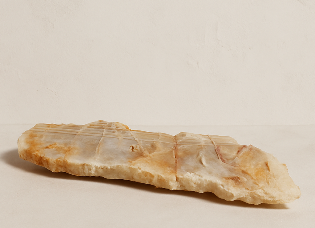 Polished agate tray in layered tan, brown, and beige tones, elongated shape with raw edge details— Luxe Natural Decor.”